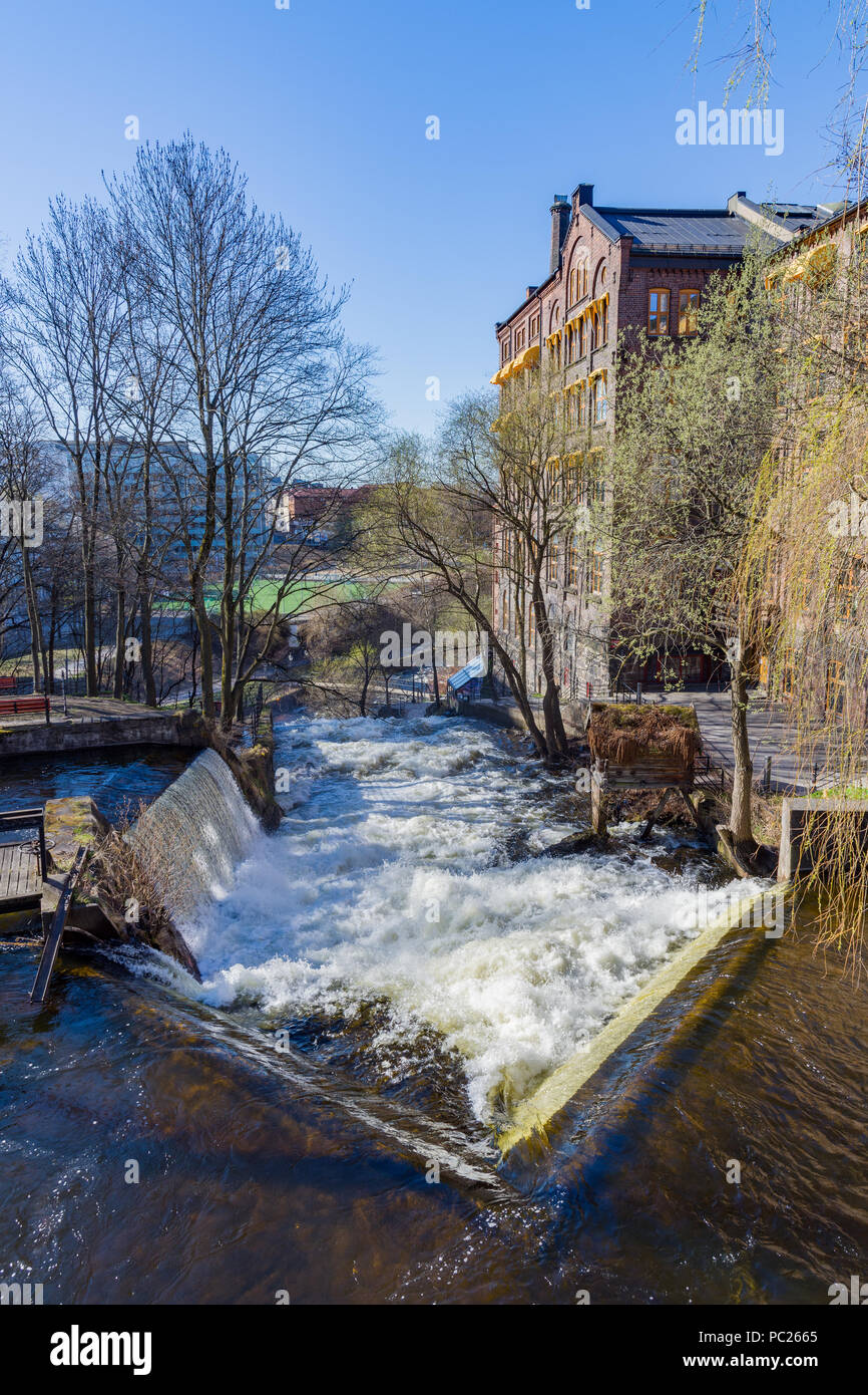 The largest waterfall of the Akerselva River in Oslo is the one near the cottage known as `Hønse-Lovisas hus`, a small red house near the Beier bridge Stock Photo